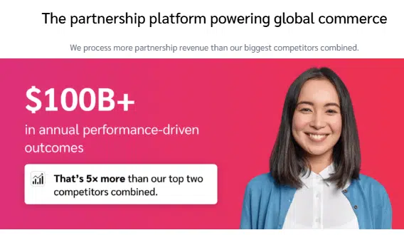Impact.com promotional graphic showing a smiling woman on a pink background with text stating ‘$100B+ in annual performance-driven outcomes’ and a note that this is ‘5x more than their top two competitors combined,’ alongside the headline ‘The partnership platform powering global commerce.